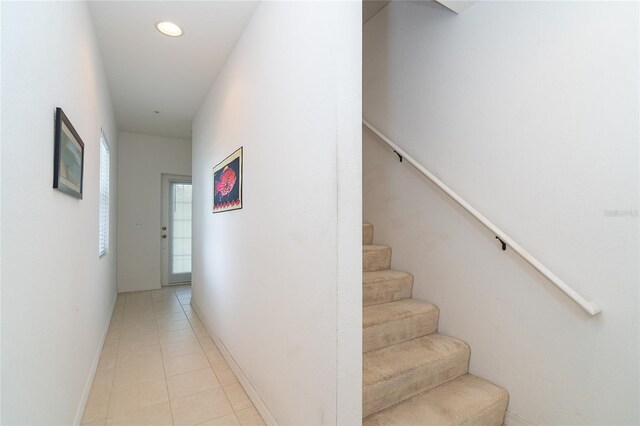 3929 Cape Haze Dr Unit 101, Rotonda West, FL 33947 - hallway with stairway, light tile patterned floors, baseboards, and recessed lighting