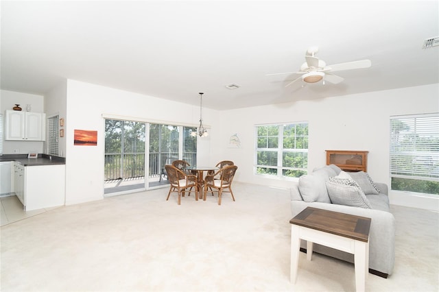 3929 Cape Haze Dr Unit 101, Rotonda West, FL 33947 - living room featuring plenty of natural light, a chandelier, and ceiling fan