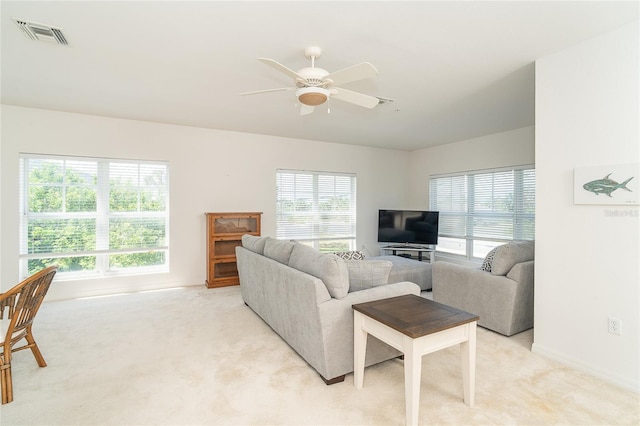 3929 Cape Haze Dr Unit 101, Rotonda West, FL 33947 - living area with light carpet, baseboards, and a ceiling fan