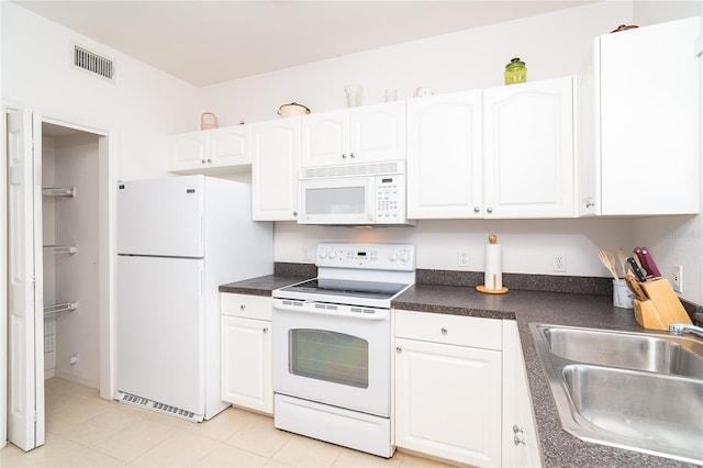 3929 Cape Haze Dr Unit 101, Rotonda West, FL 33947 - kitchen featuring white appliances, a sink, white cabinets, and dark countertops