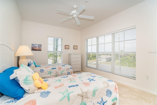 3929 Cape Haze Dr Unit 101, Rotonda West, FL 33947 - bedroom with multiple windows, baseboards, carpet flooring, and a ceiling fan