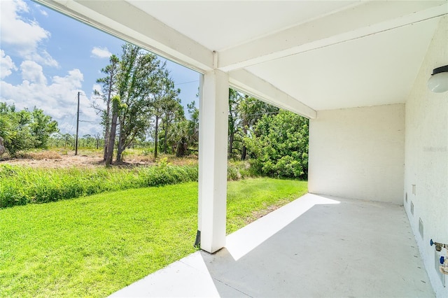 3929 Cape Haze Dr Unit 101, Rotonda West, FL 33947 - view of grassy yard with a patio
