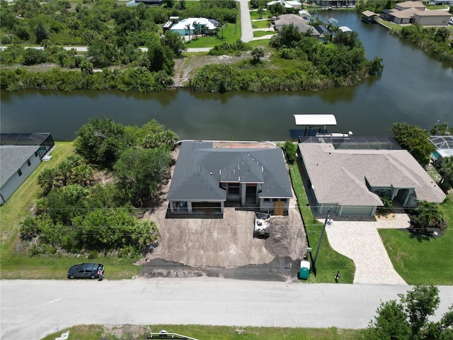 aerial view of property and surrounding area with a large body of water and nearby suburban area