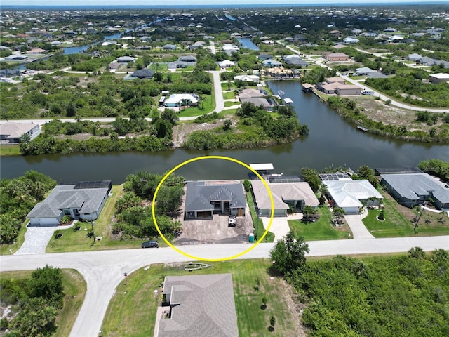 aerial perspective of suburban area with a nearby body of water
