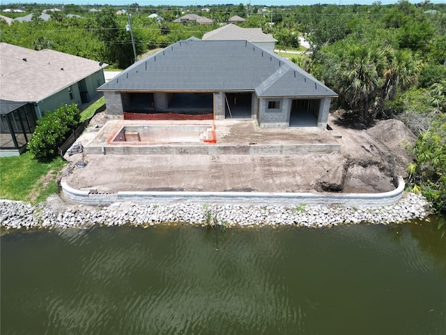aerial view of property and surrounding area with a nearby body of water