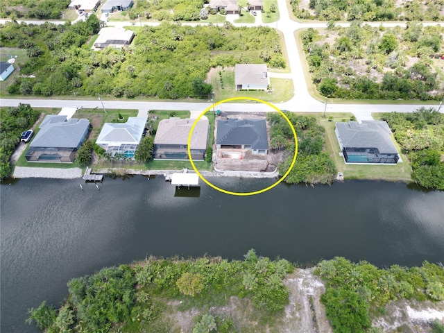 aerial perspective of suburban area with a nearby body of water