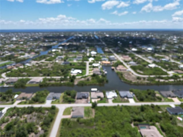 view of property location featuring nearby suburban area and a large body of water