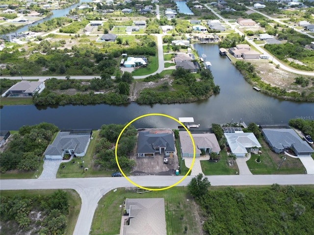 aerial view of property's location with nearby suburban area and a large body of water