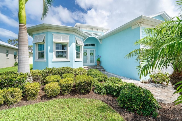 8952 Scallop Way, Placida, FL 33946 - doorway to property with french doors and stucco siding