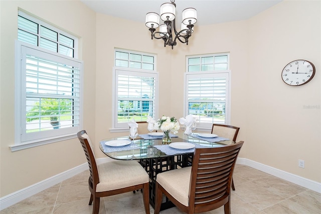 8952 Scallop Way, Placida, FL 33946 - dining room with a chandelier, light tile patterned flooring, and baseboards