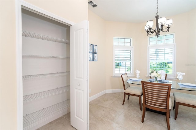 8952 Scallop Way, Placida, FL 33946 - dining area with a chandelier, light tile patterned flooring, and baseboards