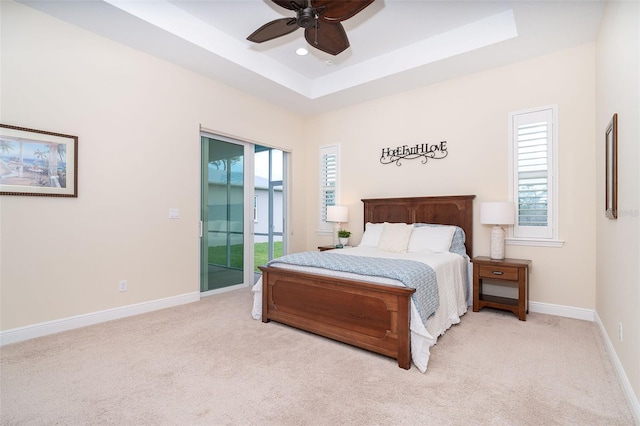 8952 Scallop Way, Placida, FL 33946 - bedroom with access to exterior, multiple windows, light colored carpet, a tray ceiling, and recessed lighting
