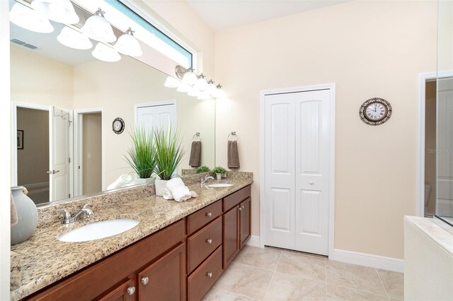 8952 Scallop Way, Placida, FL 33946 - full bath featuring double vanity, baseboards, tile patterned flooring, a towering ceiling, and a closet