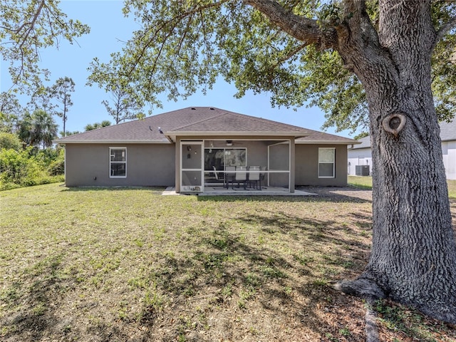 3695 Waffle Ter, North Port, FL 34286 - rear view of house with a sunroom, a yard, stucco siding, ceiling fan, and central air condition unit