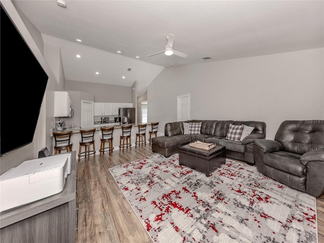 3695 Waffle Ter, North Port, FL 34286 - living area featuring lofted ceiling, a ceiling fan, light wood-type flooring, and recessed lighting