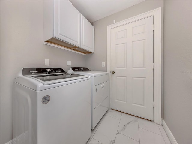 3695 Waffle Ter, North Port, FL 34286 - laundry area featuring cabinet space, washer and dryer, light marble finish flooring, and baseboards