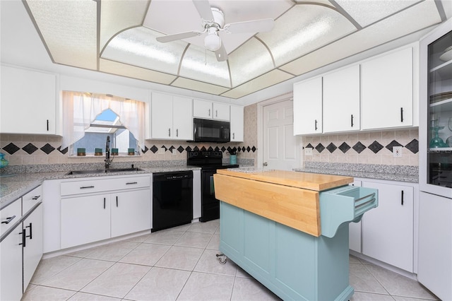 146 Rotonda Cir, Rotonda West, FL 33947 - kitchen featuring black appliances, a sink, wood counters, and backsplash