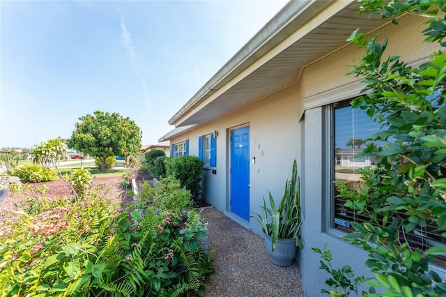 146 Rotonda Cir, Rotonda West, FL 33947 - doorway to property with stucco siding