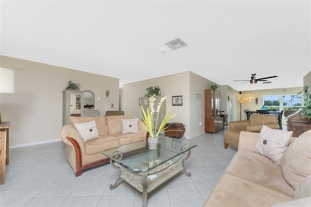 146 Rotonda Cir, Rotonda West, FL 33947 - living area featuring light tile patterned floors, a ceiling fan, and baseboards