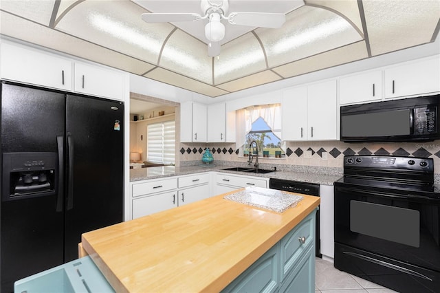 146 Rotonda Cir, Rotonda West, FL 33947 - kitchen featuring black appliances, a sink, white cabinets, and butcher block countertops
