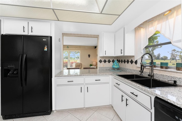 146 Rotonda Cir, Rotonda West, FL 33947 - kitchen featuring black appliances, a sink, backsplash, and white cabinetry