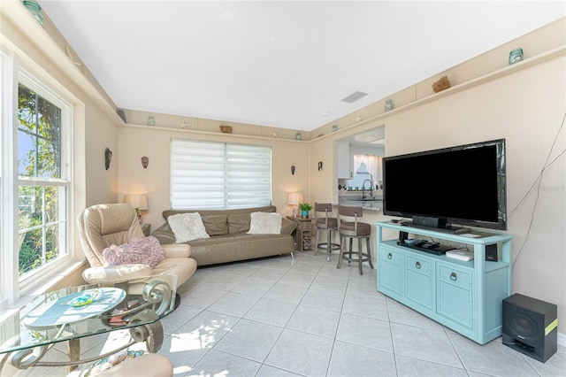 146 Rotonda Cir, Rotonda West, FL 33947 - living room with light tile patterned floors and healthy amount of natural light