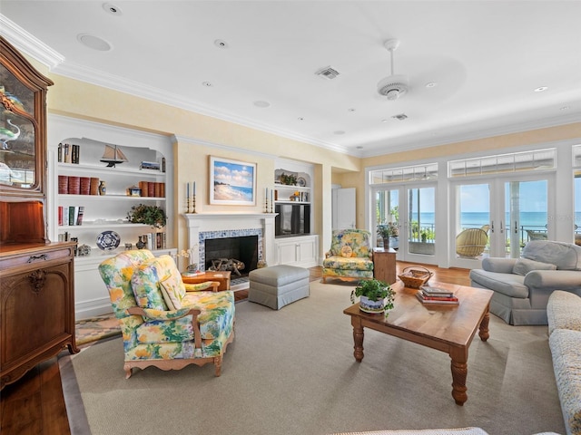 2979 Shore Ln, Boca Grande, FL 33921 - living room with ornamental molding, built in shelves, and a fireplace