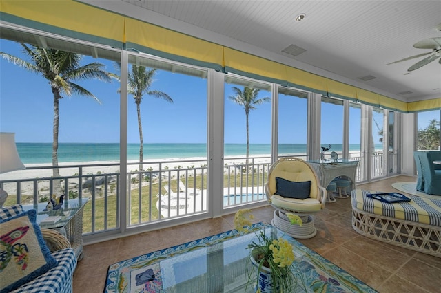2979 Shore Ln, Boca Grande, FL 33921 - sunroom / solarium featuring view of water and beach and tile patterned floors