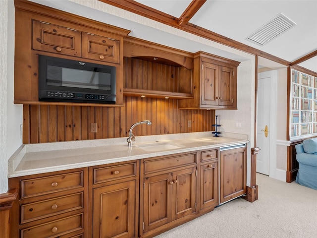 2979 Shore Ln, Boca Grande, FL 33921 - kitchen with a sink, black microwave, brown cabinetry, light countertops, and open shelves