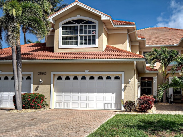 2590 Tarpon Cove Dr Unit 811, Punta Gorda, FL 33950 - mediterranean / spanish house with a tiled roof, stucco siding, and decorative driveway