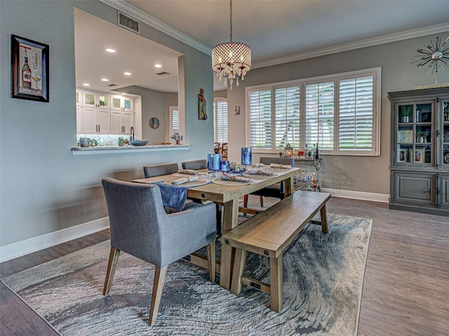 2590 Tarpon Cove Dr Unit 811, Punta Gorda, FL 33950 - dining area with baseboards, wood finished floors, a chandelier, crown molding, and recessed lighting