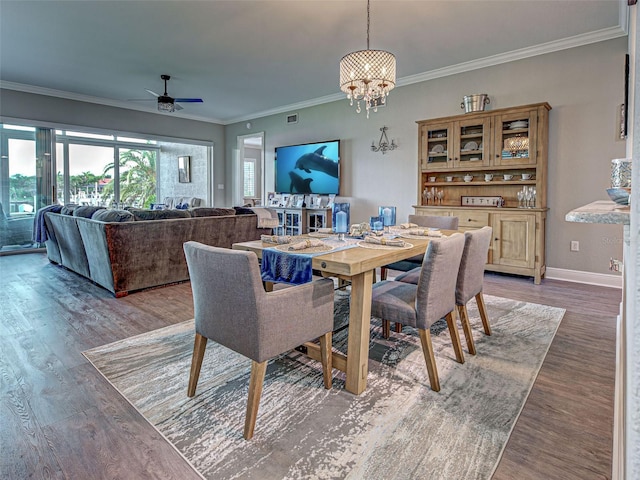 2590 Tarpon Cove Dr Unit 811, Punta Gorda, FL 33950 - dining room with a chandelier, wood finished floors, crown molding, a ceiling fan, and baseboards