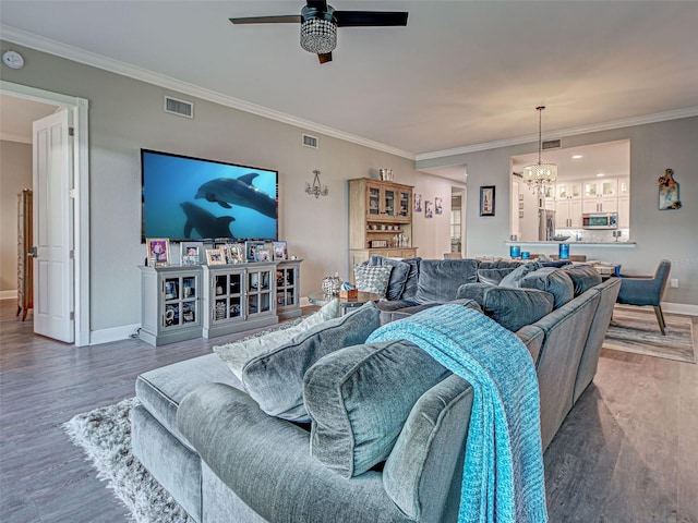 2590 Tarpon Cove Dr Unit 811, Punta Gorda, FL 33950 - living room with a ceiling fan, wood finished floors, baseboards, a chandelier, and crown molding