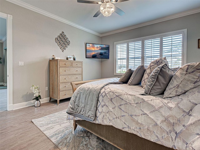 2590 Tarpon Cove Dr Unit 811, Punta Gorda, FL 33950 - bedroom featuring ornamental molding, multiple windows, wood finished floors, baseboards, and ceiling fan