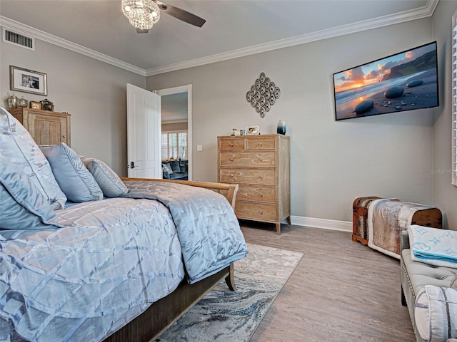 2590 Tarpon Cove Dr Unit 811, Punta Gorda, FL 33950 - bedroom with baseboards, light wood-style floors, and ornamental molding