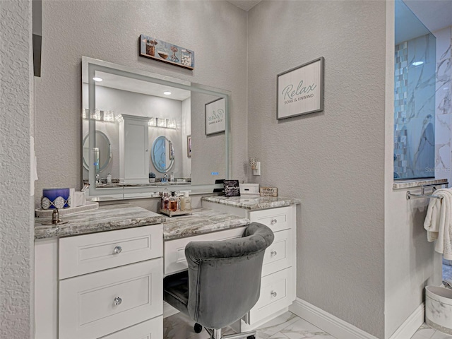 2590 Tarpon Cove Dr Unit 811, Punta Gorda, FL 33950 - bathroom featuring marble look tile flooring, vanity, baseboards, and a textured wall