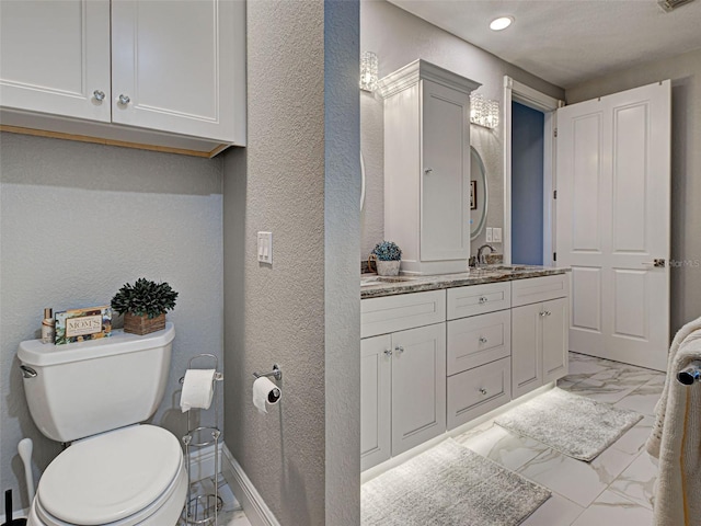 2590 Tarpon Cove Dr Unit 811, Punta Gorda, FL 33950 - bathroom featuring marble finish floors, a textured wall, vanity, recessed lighting, and toilet