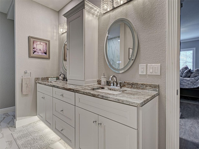 2590 Tarpon Cove Dr Unit 811, Punta Gorda, FL 33950 - bathroom with marble finish flooring, double vanity, ensuite bath, baseboards, and a textured wall