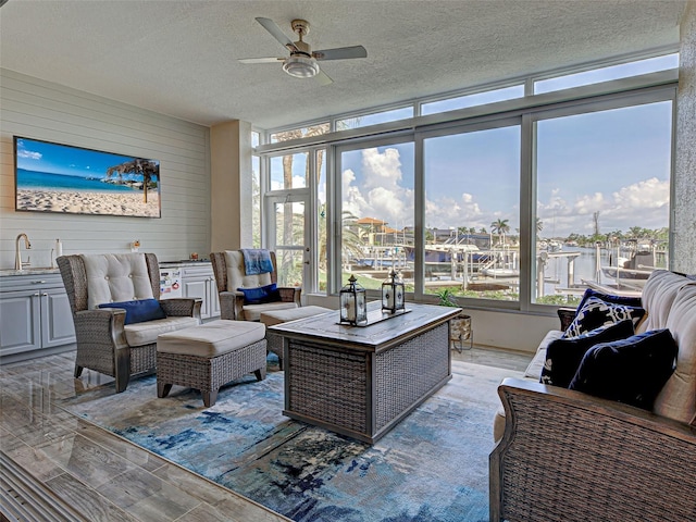 2590 Tarpon Cove Dr Unit 811, Punta Gorda, FL 33950 - living room with a ceiling fan, a textured ceiling, light wood finished floors, and wood walls