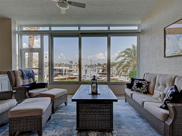 2590 Tarpon Cove Dr Unit 811, Punta Gorda, FL 33950 - living area featuring a ceiling fan, a textured ceiling, healthy amount of natural light, and a textured wall