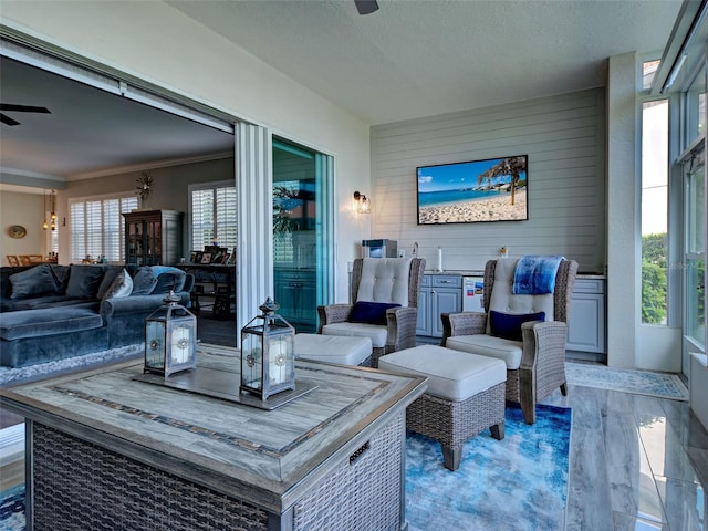 2590 Tarpon Cove Dr Unit 811, Punta Gorda, FL 33950 - living room featuring a ceiling fan, wood finished floors, ornamental molding, and a textured ceiling