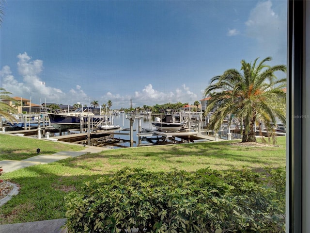2590 Tarpon Cove Dr Unit 811, Punta Gorda, FL 33950 - dock featuring boat lift, a water view, and a lawn