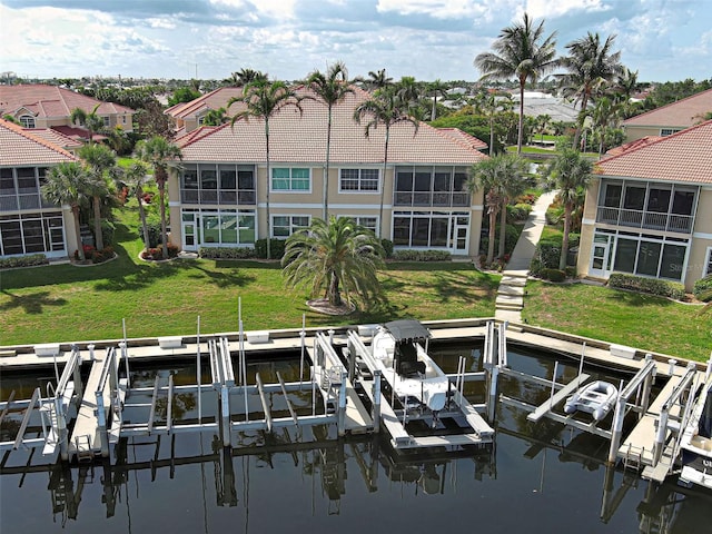 2590 Tarpon Cove Dr Unit 811, Punta Gorda, FL 33950 - dock featuring boat lift, a water view, a residential view, and a lawn