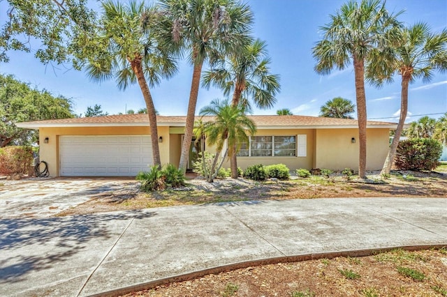 500 Green Dolphin Dr S, Placida, FL 33946 - ranch-style home with a garage, stucco siding, and driveway