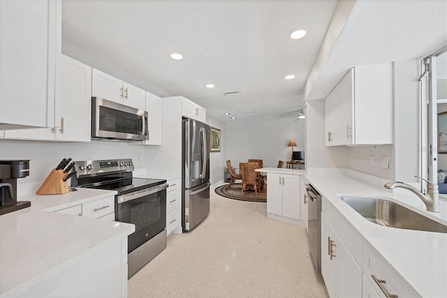 500 Green Dolphin Dr S, Placida, FL 33946 - kitchen with stainless steel appliances, recessed lighting, white cabinetry, light countertops, and ceiling fan