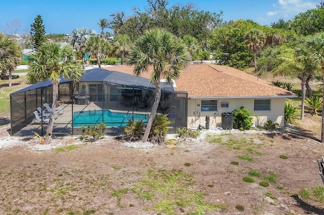 500 Green Dolphin Dr S, Placida, FL 33946 - rear view of house featuring an outdoor pool, a patio area, glass enclosure, and stucco siding