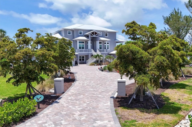 565 Green Dolphin Dr S, Placida, FL 33946 - beach home with stairway, stucco siding, and a balcony
