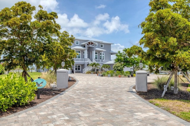 565 Green Dolphin Dr S, Placida, FL 33946 - coastal home with stairway and a balcony