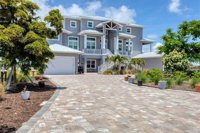 565 Green Dolphin Dr S, Placida, FL 33946 - raised beach house with stairs, stucco siding, metal roof, and a standing seam roof