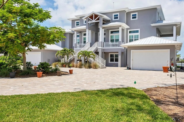 565 Green Dolphin Dr S, Placida, FL 33946 - view of front of property with stairway, stucco siding, decorative driveway, and a porch